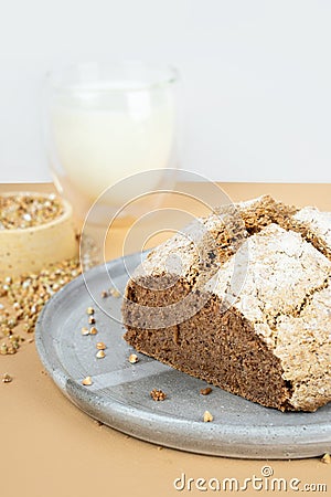 Minimalistic creative beige background with green buckwheat bread nd organic buckwheat milk. Harmless, wellness, gluten free Stock Photo