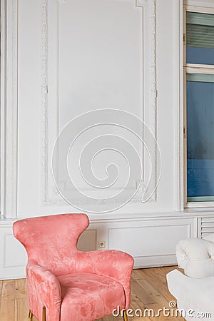 Minimalistic and luxury pastel pink home interior with velvet design armchair, big window.classical style Armchair in Stock Photo
