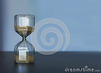 Minimalistic Photo With Sand Clock On Blue Background Stock Photo