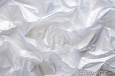 Minimalistic white texture of transparent wrinkled plastic. Crumpled wrinkled plastic cellophane. Reflects light and shadow on the Stock Photo