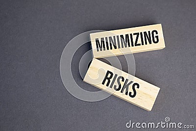 minimizing risks words on wooden blocks on yellow background. Business ethics concept Stock Photo