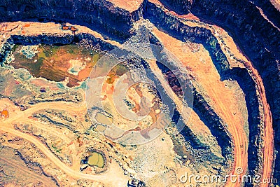 Mining from above. Industrial open pit mineral mine. Aerial view of opencast mining. Mine Excavation. Extractive industry. Giant Stock Photo