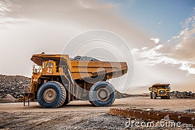 Mining dump trucks transporting Platinum ore for processing Stock Photo