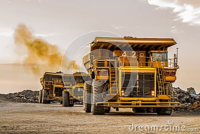 Mining dump trucks transporting Platinum ore for processing Stock Photo