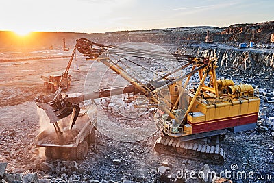 Mining. excavator loading granite or ore into dump truck Stock Photo