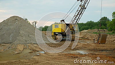 Mining gravel sand pit excavator digger dredger extraction machine colliery output quarry building gray pile mine surface grit Stock Photo