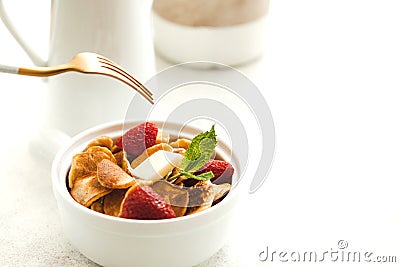 Minipancakes breakfast - white bowl with strawberries and pancakes, mik jar, honey, fresh mint and house plant. Lifestyle morning Stock Photo