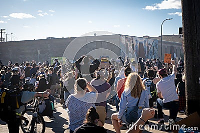 live protestors kneel before state patrol police officers in the streets in minneapolis riots Editorial Stock Photo