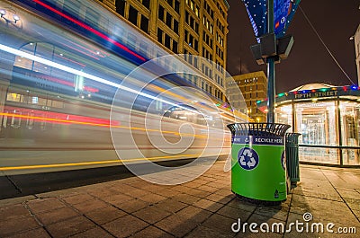 Long exposure at night of a Minneapolis Minnesota MetroTransit bus speeding by a bus shelter on Editorial Stock Photo