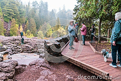 Crowds of tourists gather on boardwalk overlook to see Gooseberry Falls waterfall at the state Editorial Stock Photo