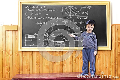 Minor child write complicated formulas on lackboard Stock Photo