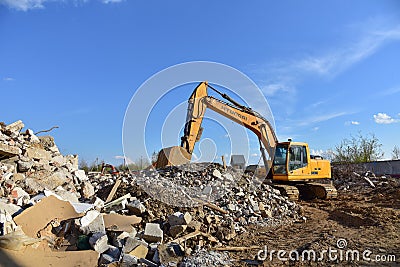 Excavator HYUNDAI work at landfill with concrete demolition waste. Salvaging and recycling building and Editorial Stock Photo