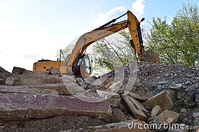 Excavator HYUNDAI work at landfill with concrete demolition waste. Salvaging and recycling building and Editorial Stock Photo