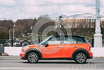 Minsk, Belarus. Orange Color Mini Cooper All 4 Car In Motion On Street Editorial Stock Photo
