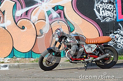 Street art on Oktyabrskaya street, Minsk, Belarus. Graffiti on concrete fence. Motorcycle Moto Guzzi Editorial Stock Photo