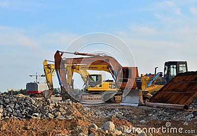 Bulldozer Shantui and Group Excavators brands of the Hyundai, Kraneks, Komatsu with hydraulic shears Editorial Stock Photo