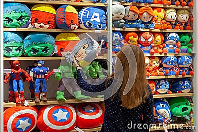 MINSK, BELARUS - December 20, 2019: Buyer chooses toys superheroes of Marvel universe made by Miniso. Editorial Stock Photo