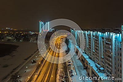 MINSK, BELARUS - DECEMBER 2018: lights of the night city. Light skyscraper reflected in the lake water Editorial Stock Photo