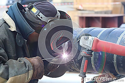 welder at work. Close up photo of factory worker Editorial Stock Photo