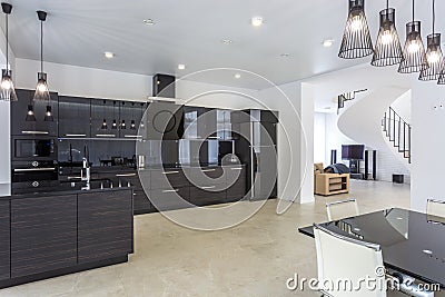 MINSK, BELARUS - JANUARY, 2019: Interior of the modern kitchen and guest hall in loft flat in minimalistic style with black color Editorial Stock Photo