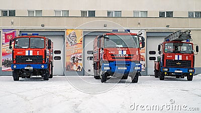 Three fire trucks near the building of fire rescuers. Front view Editorial Stock Photo