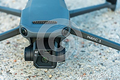 Minsk, Belarus, June 1, 2022: New drone DJI mavic 3 is standing on a concrete surface. Parts of a new modern quadcopter in close- Editorial Stock Photo