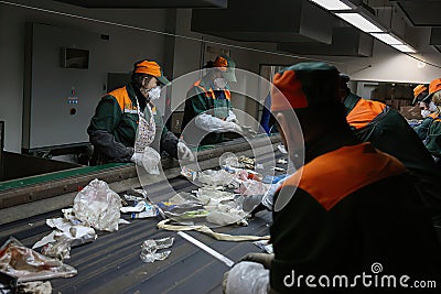 Conveyor for sorting garbage waste by people. Garbage processing Editorial Stock Photo