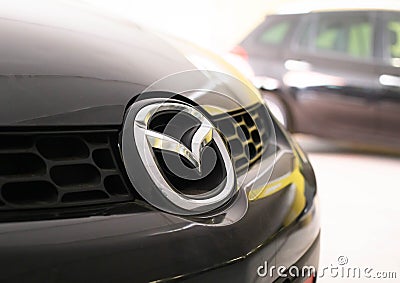 MINSK, BELARUS 07.10.19: Mazda car emblem on the car hood. Concept of brand and quality cars, close-up Editorial Stock Photo