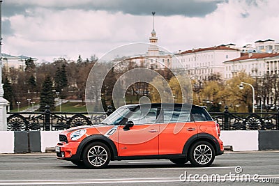 Minsk, Belarus. Orange Color Mini Cooper All 4 Car With Woman Dr Editorial Stock Photo