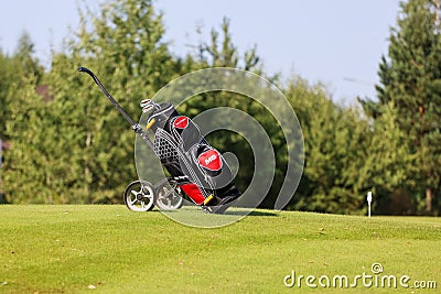 Minsk. Belarus - 25.07.2021 - Push-Pull Golf Carts. Green grass, trees. Editorial Stock Photo