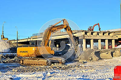 Repair of the ring road bridge. Excavators dismantle slabs. Concrete crushing by earth-moving machine. Editorial Stock Photo