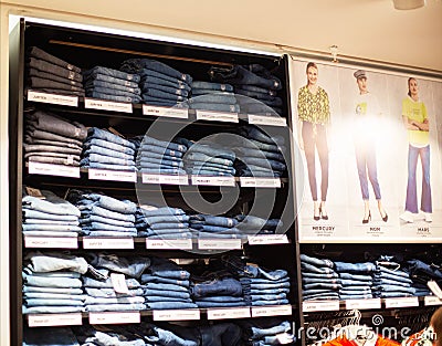 MINSK, BELARUS 4.11.2019: Stylish and high-tech pants jeans are sold on the shelves in the store, background, sale Editorial Stock Photo