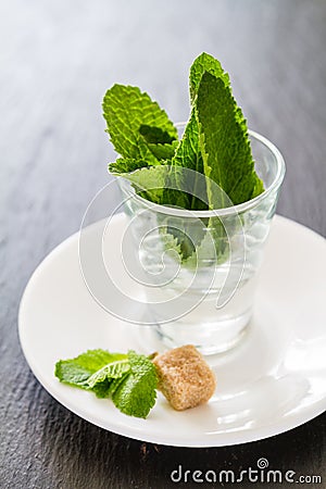 Mint in glass cups, chocolate, nuts Stock Photo