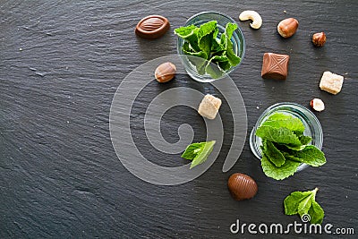 Mint in glass cups, chocolate, nuts Stock Photo