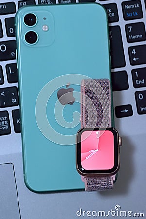 Mint Green color iPhone 11 with apple watch Editorial Stock Photo