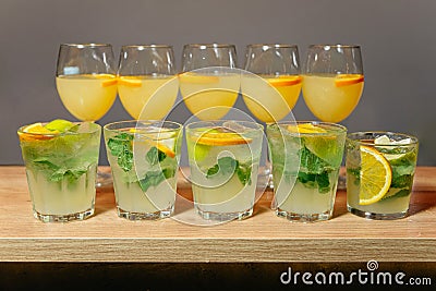 Mint Mojitos and Orange Cocktails on Wooden Bar Stock Photo