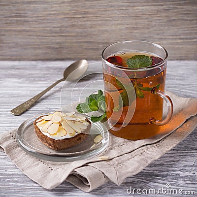 Mint tea and cake with cream and almond petals Stock Photo