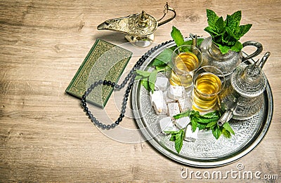 Mint tea, delight, arabian lantern, holy book quran and rosary. Stock Photo