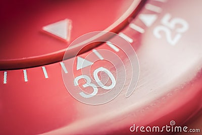 30 Minutes - Macro Of A Flat Red Kitchen Egg Timer Stock Photo