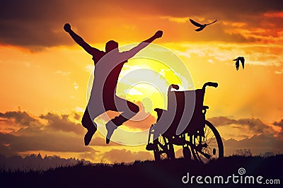 A miracle happened. Disabled handicapped man is healthy again. He is happy and jumping at sunset Stock Photo