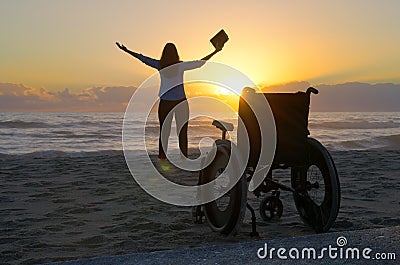 Miracle spiritual healing crippled woman walking at beach at sun Stock Photo