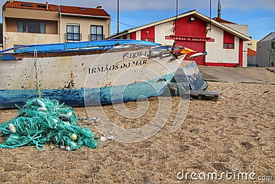 Fishing boats damaged by storms stranded on Aguda beach, Porto Editorial Stock Photo