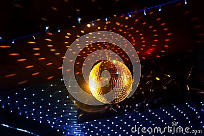 Mirror disco ball with light reflection on the ceiling Stock Photo