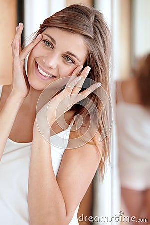 Mirror, facial massage and happy woman in bathroom for morning skincare routine, dermatology and beauty. Smile Stock Photo