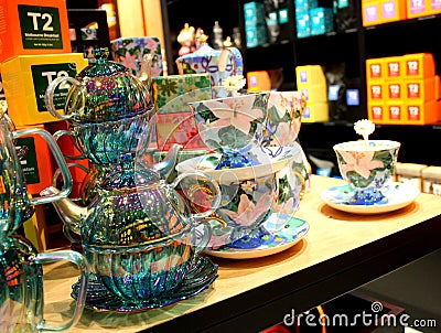 Mirror finish tea pots placed on one another on a table for display Editorial Stock Photo