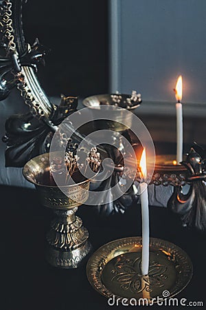 Mirror magick witchcraft - scrying with a white lit burning candle to read the flame. A reflection of skinny candle stick Stock Photo