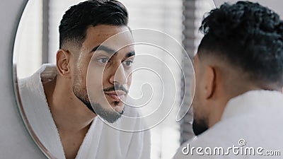 Mirror reflection portrait arabian arab indian bearded man washing face male wet face with hot cold water guy morning Stock Photo