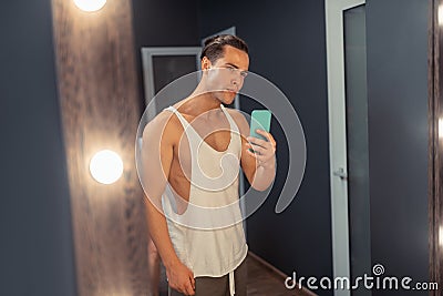 Nice attractive man taking a selfie in the mirror Stock Photo