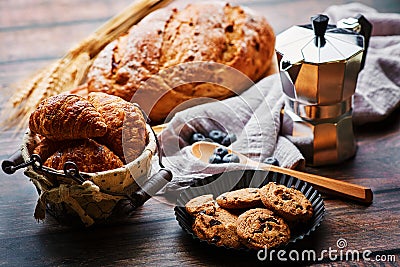 Miscellaneous delicious pastry and coffee pot on the wooden table Stock Photo
