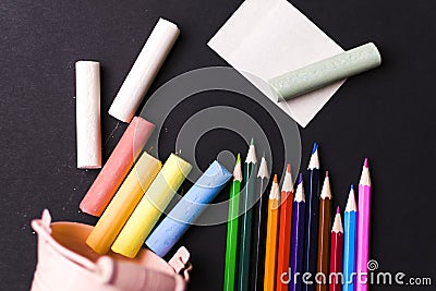 Miscellaneous school supplies, chalk, glass knobs on a dark background. The concept study. Stock Photo